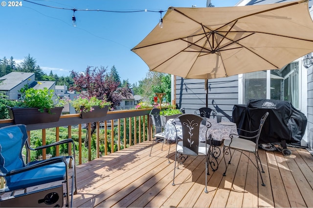 wooden deck featuring a grill