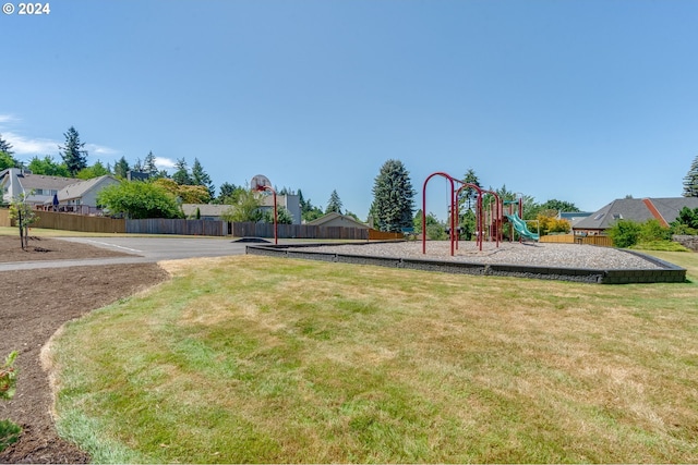 view of jungle gym featuring a yard and basketball court