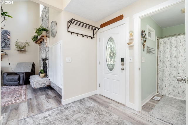 foyer featuring a textured ceiling and light hardwood / wood-style floors