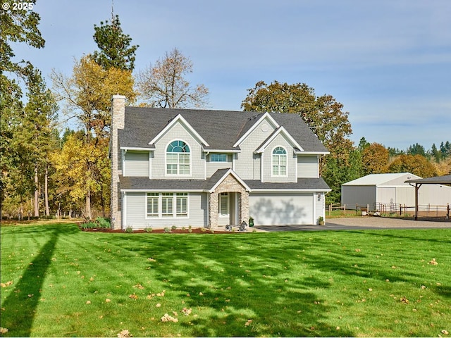 view of front of house featuring a front lawn and a garage