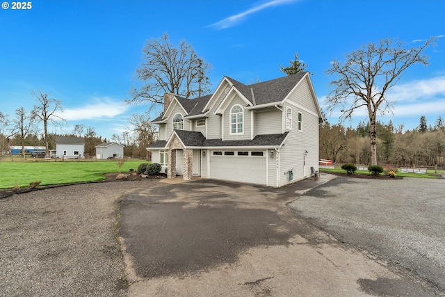 view of front of house with a garage and a front lawn