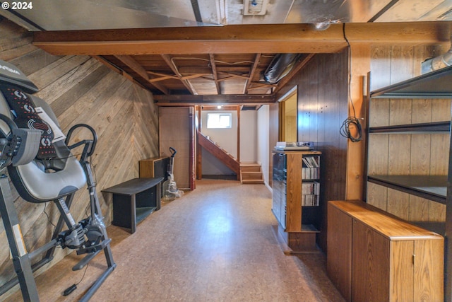 basement featuring wood walls