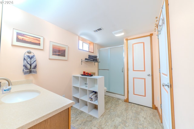 bathroom featuring walk in shower, vanity, and toilet