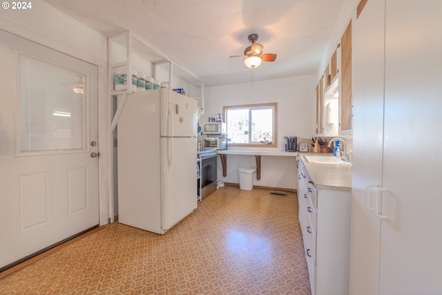 kitchen featuring sink, white cabinetry, stainless steel stove, white fridge, and ceiling fan