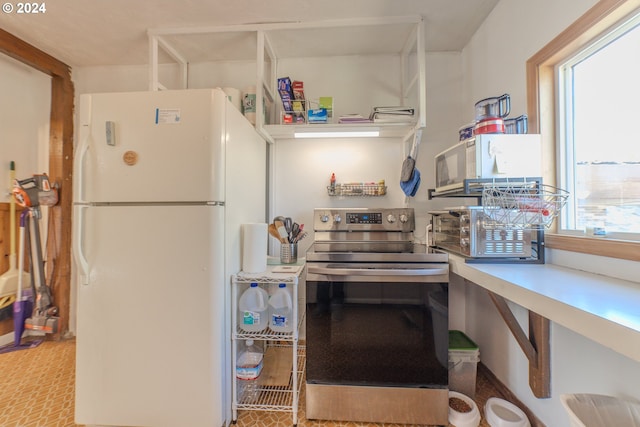 kitchen with white appliances and a healthy amount of sunlight