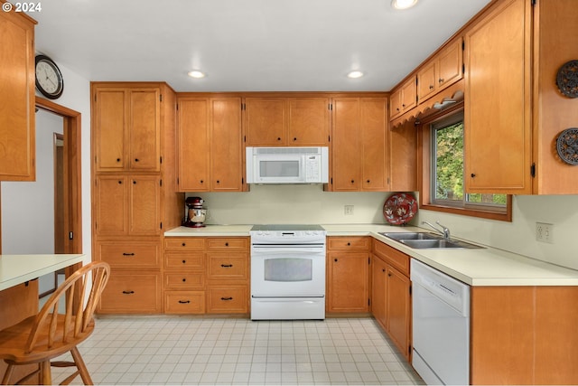 kitchen featuring white appliances and sink