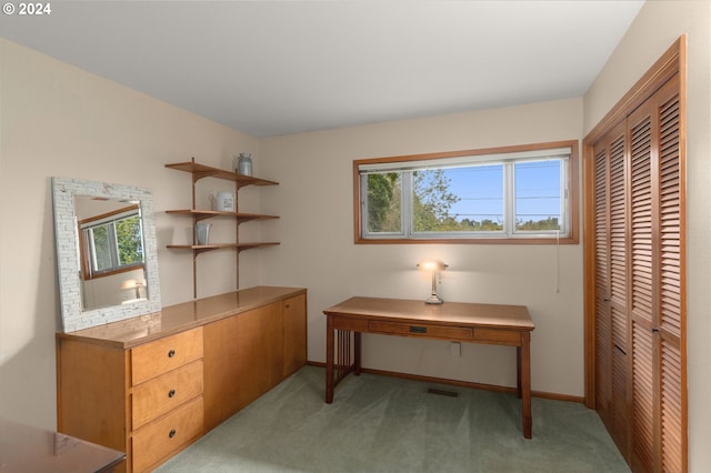 office space featuring plenty of natural light and light colored carpet