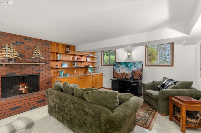 living room featuring a brick fireplace, light carpet, and a textured ceiling