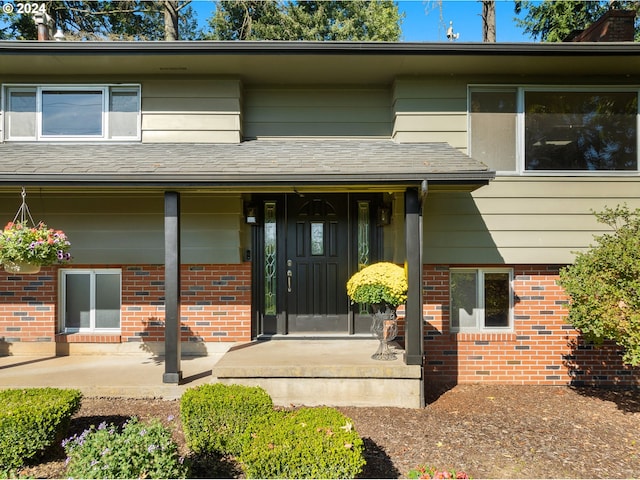 view of exterior entry with a porch