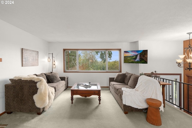 carpeted living room with a chandelier