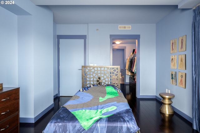 bedroom featuring dark hardwood / wood-style floors and a closet