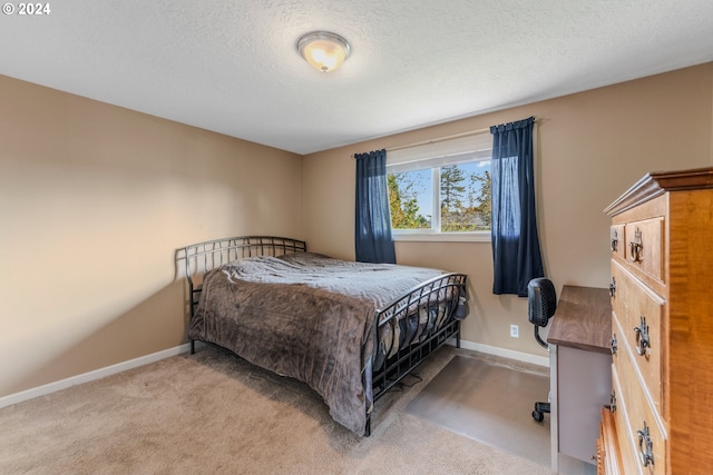 carpeted bedroom featuring a textured ceiling