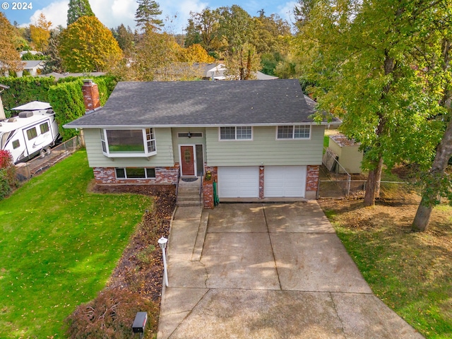 split foyer home featuring a front yard and a garage