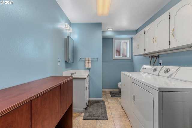 washroom featuring independent washer and dryer, sink, and light tile patterned floors