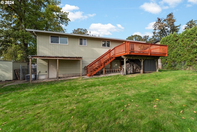 rear view of house with a wooden deck and a yard