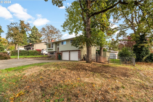 split foyer home featuring a front yard and a garage