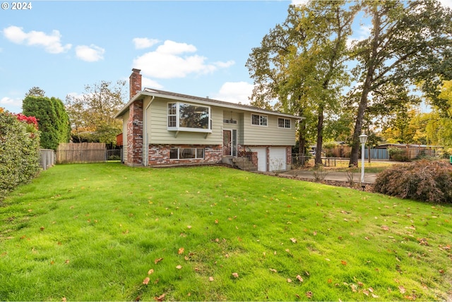 bi-level home featuring a front yard and a garage