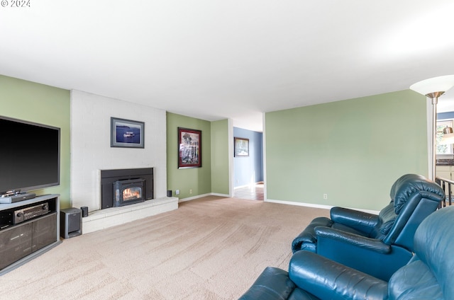 living room featuring light carpet and a fireplace