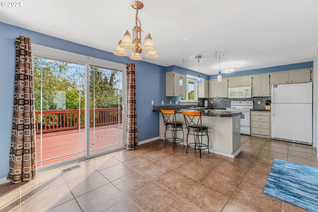 kitchen featuring white appliances, decorative backsplash, kitchen peninsula, and tile patterned flooring