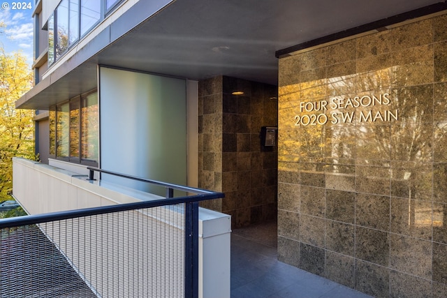 exterior space with dark tile patterned floors and tile walls