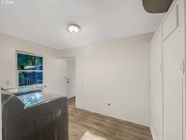 kitchen featuring washing machine and clothes dryer and light hardwood / wood-style flooring