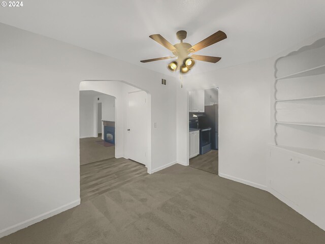 carpeted empty room with ceiling fan