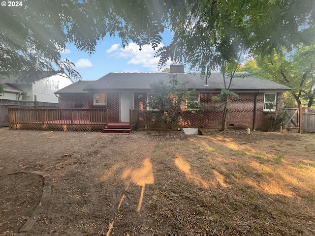 rear view of house with a wooden deck