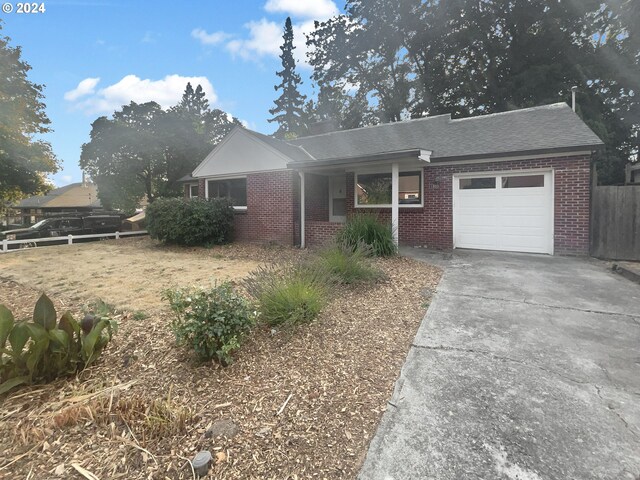 ranch-style house featuring a garage