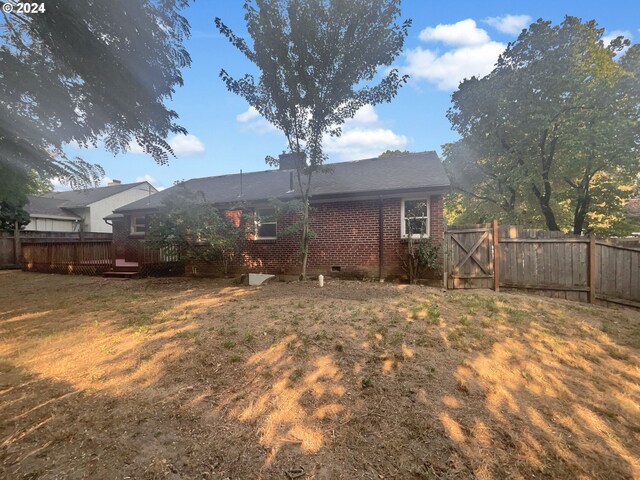 rear view of property featuring a wooden deck