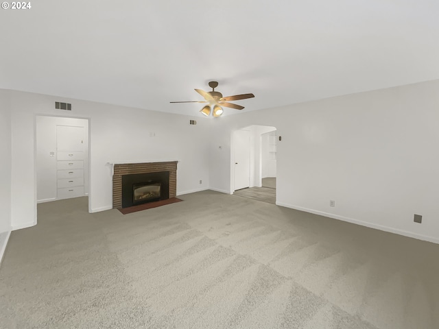 unfurnished living room with light carpet and ceiling fan