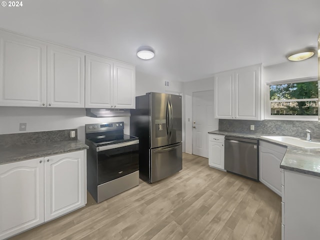 kitchen with white cabinets, light wood-type flooring, stainless steel appliances, and sink