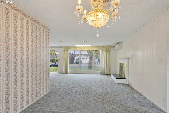 hallway with carpet floors, a wall unit AC, visible vents, a textured ceiling, and a chandelier