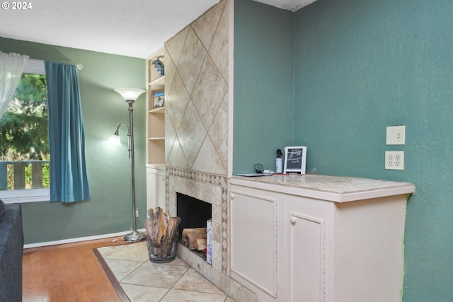 interior space featuring a tile fireplace and hardwood / wood-style floors