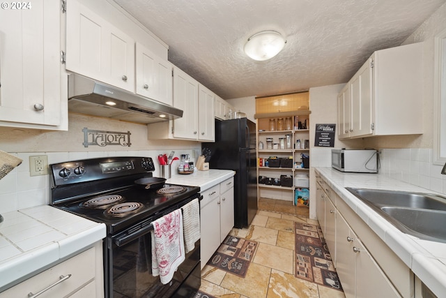 kitchen with backsplash, a textured ceiling, black appliances, and white cabinetry