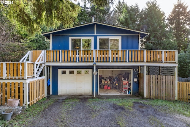 view of front property with a deck and a garage