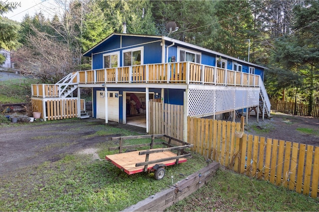 back of house with a wooden deck