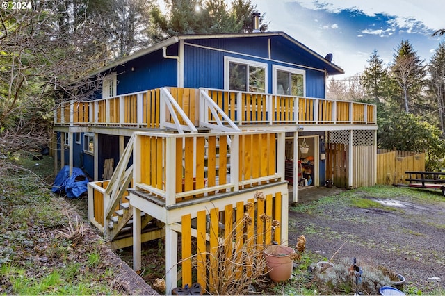 back of house featuring a wooden deck