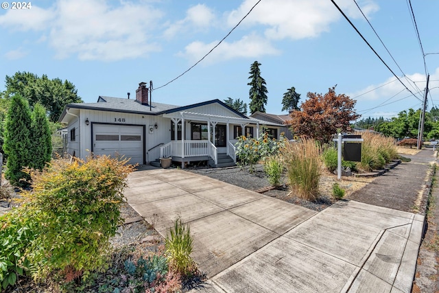 single story home featuring covered porch and a garage