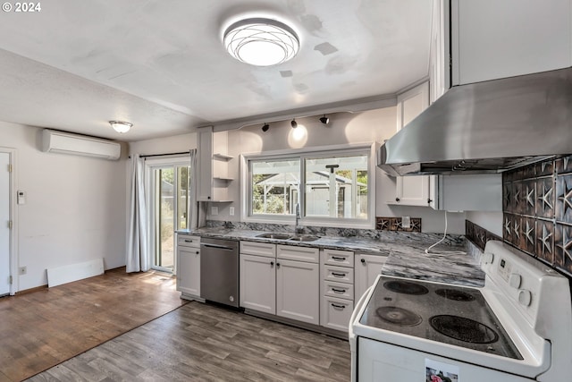 kitchen with an AC wall unit, stainless steel dishwasher, white cabinets, sink, and electric range