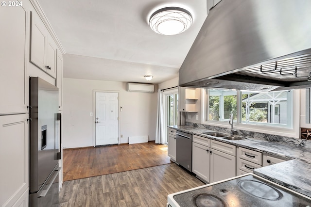 kitchen with sink, white cabinets, dark wood-type flooring, an AC wall unit, and stainless steel appliances