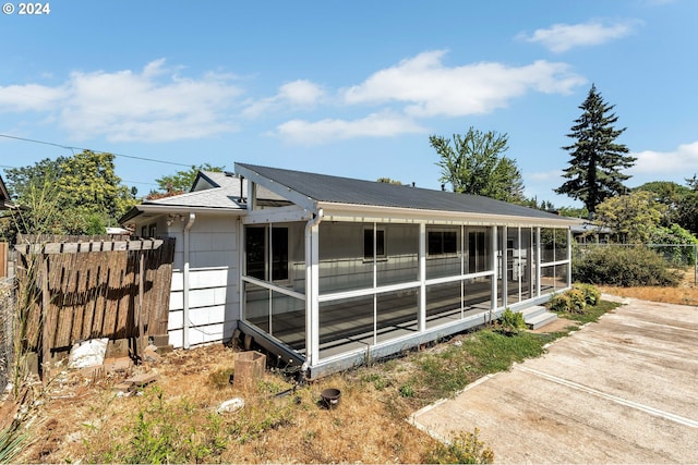 view of side of home featuring a sunroom