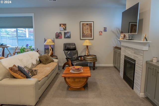 living room with light carpet, a glass covered fireplace, visible vents, and baseboards