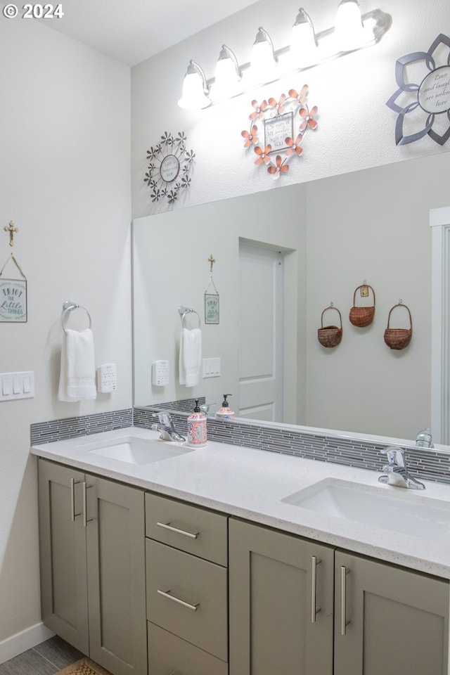 full bath with double vanity and a sink