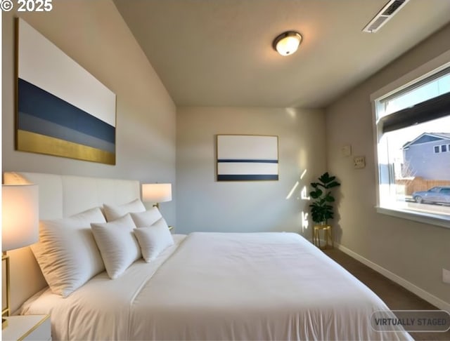 bedroom with visible vents, multiple windows, and baseboards