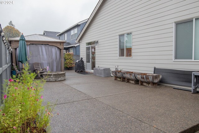 view of patio / terrace featuring a gazebo and a fire pit