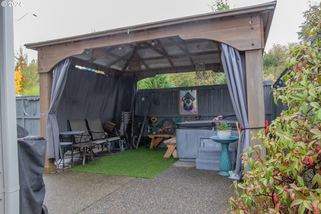 exterior space with a gazebo, fence, and a carport