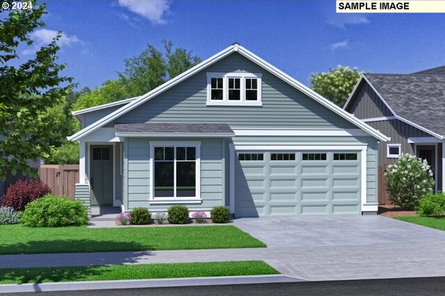 view of front of house featuring a front lawn and a garage