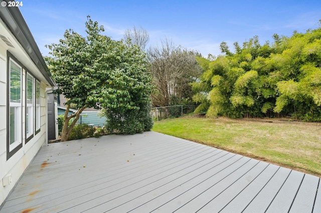 wooden terrace featuring a lawn