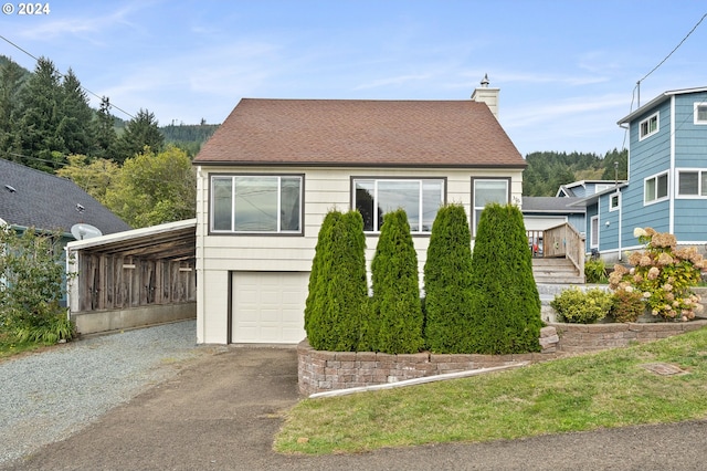 view of front of property featuring a carport and a garage