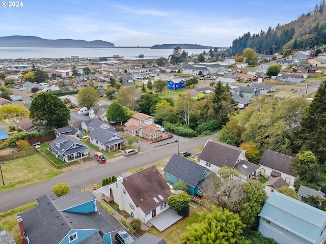 drone / aerial view featuring a water and mountain view